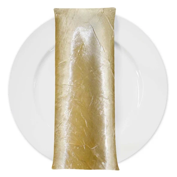 The champagne gold crushed satin napkin on a white plate