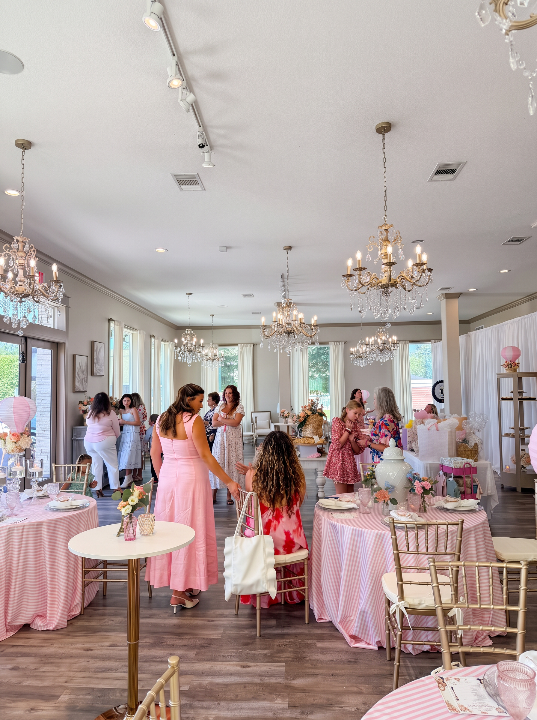 Guests mingling among dressed tables during a celebration