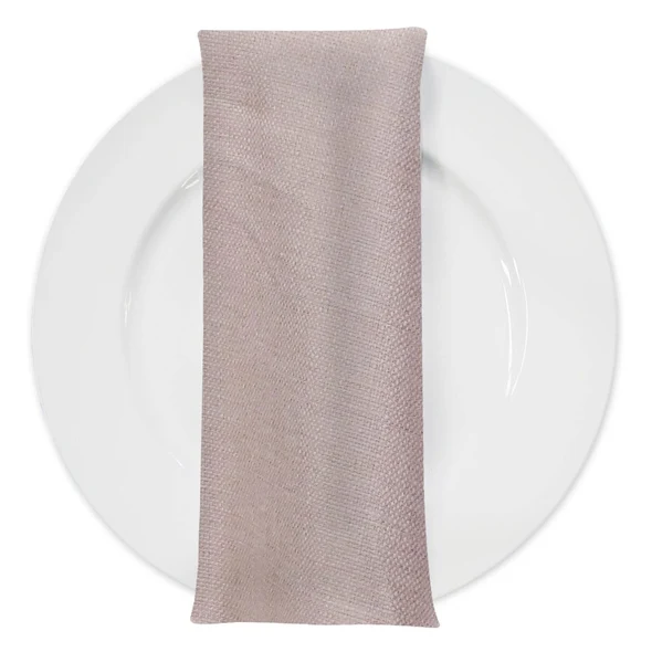 Blush-taupe linen napkin on a white dinner plate