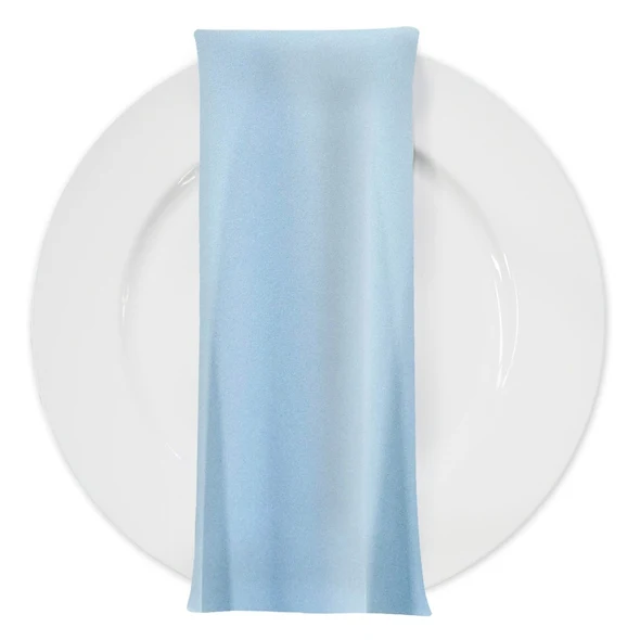 Pale sky blue napkin on a white dinner plate