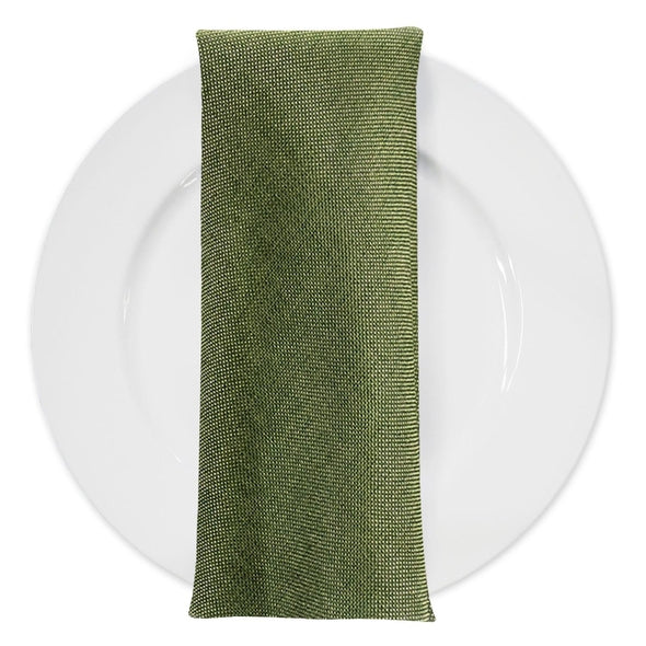 The moss green napkin on a white plate