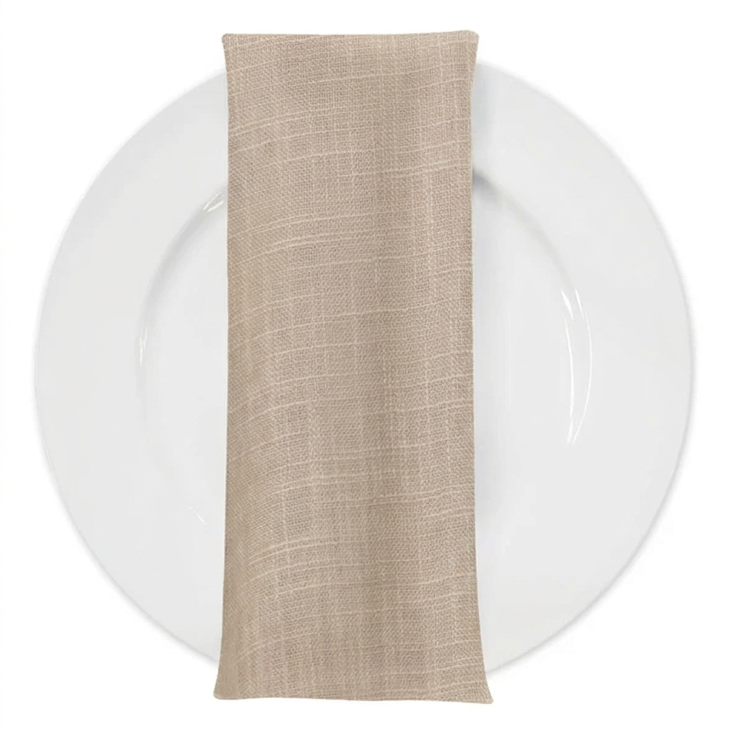 Matching soft warm beige textured napkin on a white plate
